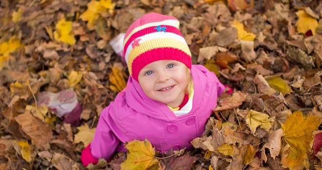 Child-in-autumn-leaves-24752852.jpg