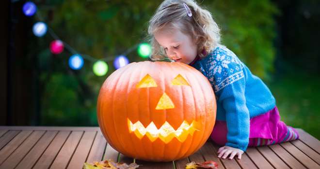 Little-Girl-Carving-Pumpkin-At-98115704.jpg